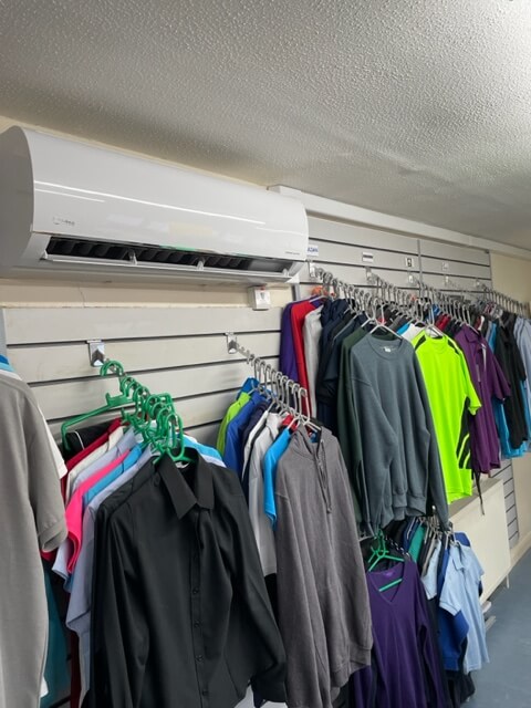 air conditioning unit installed in showroom surrounded by clothing