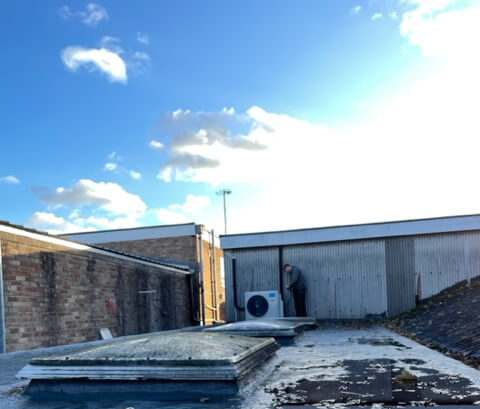 Air conditioning engineer installing condenser unit