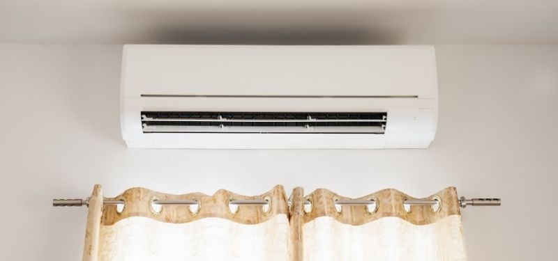 air conditioning unit above curtains