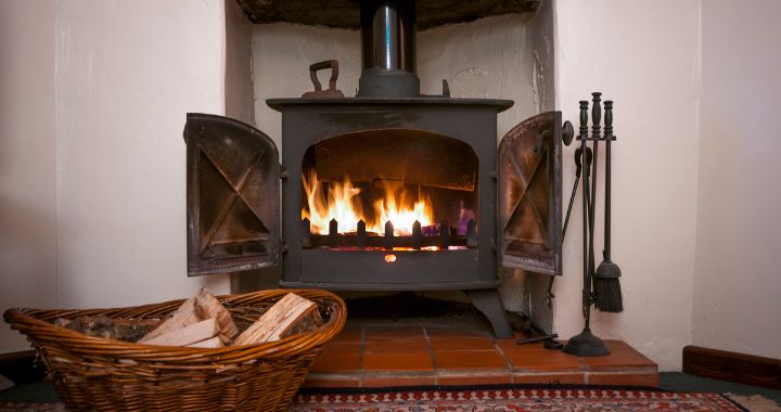 Wood-burning stove with a basket of wood