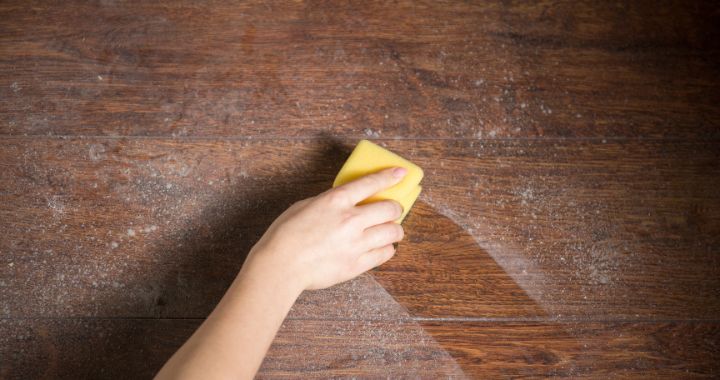Dusty surface being wiped with a sponge