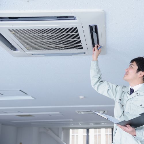 Man checking ceiling ac uit