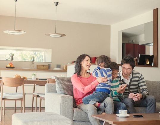 happy family on sofa in living room
