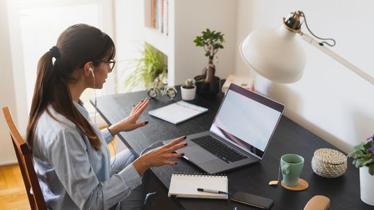 woman working from home in home office on a call